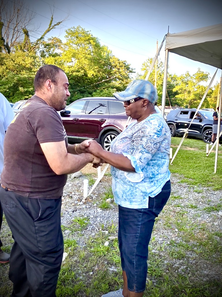 Two people holding hands in support